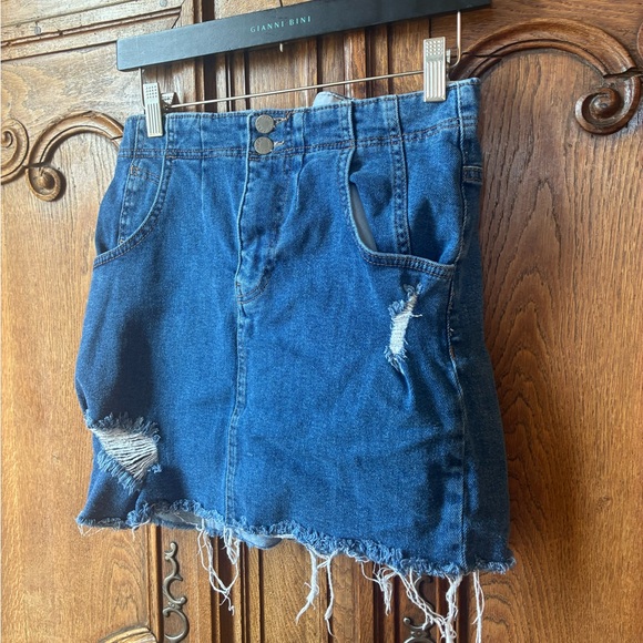 Free People distressed denim mini skirt with a buckle back and raw hem. - Picture 3 of 16